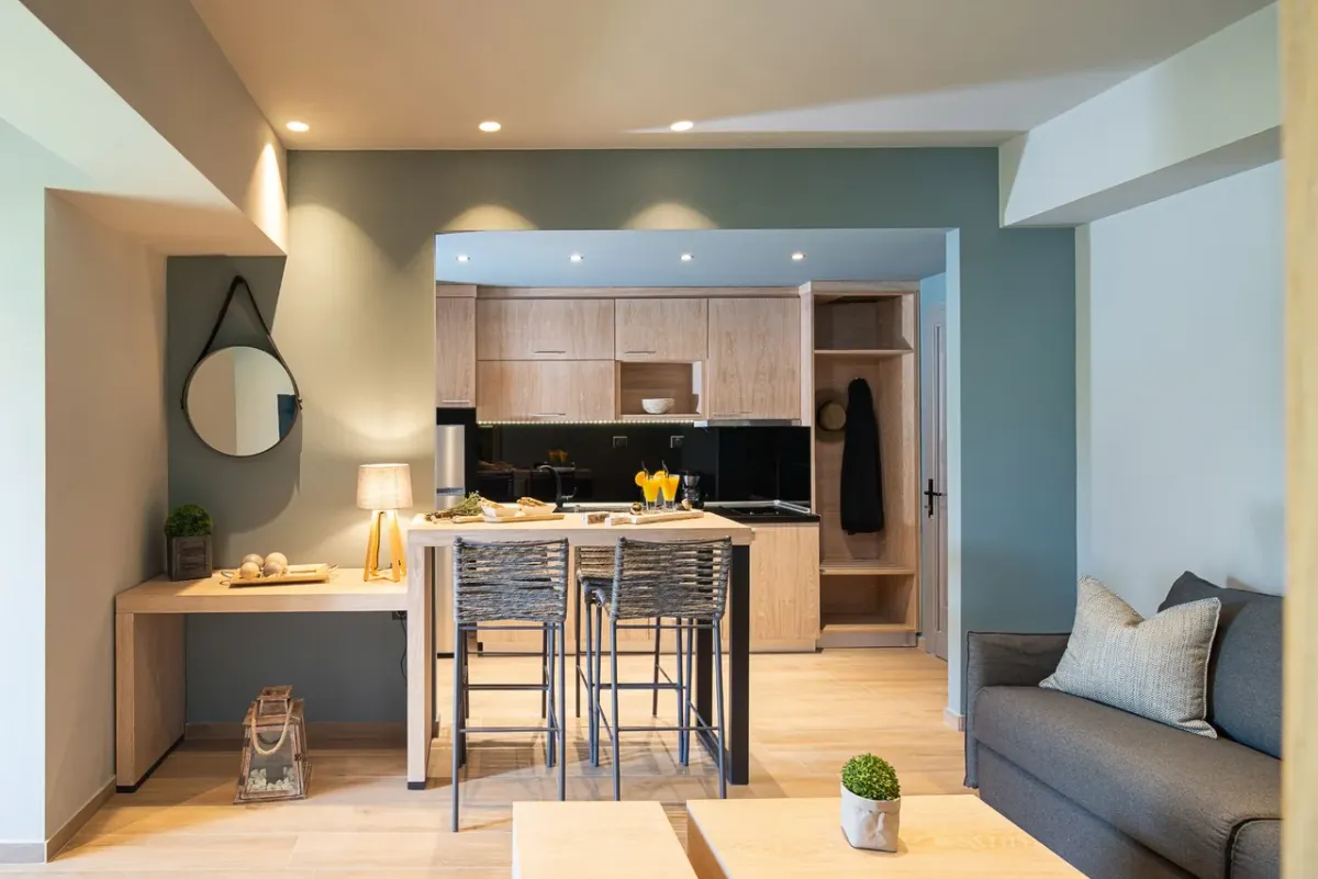 Bright open-plan living and kitchen area inside a custom in-law garden suite with large windows