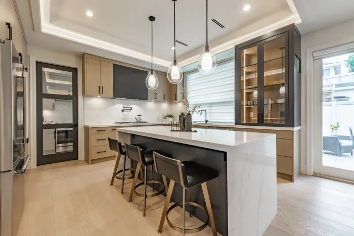 Kitchen with white island and full-size appliances inside a two-bedroom garden suite